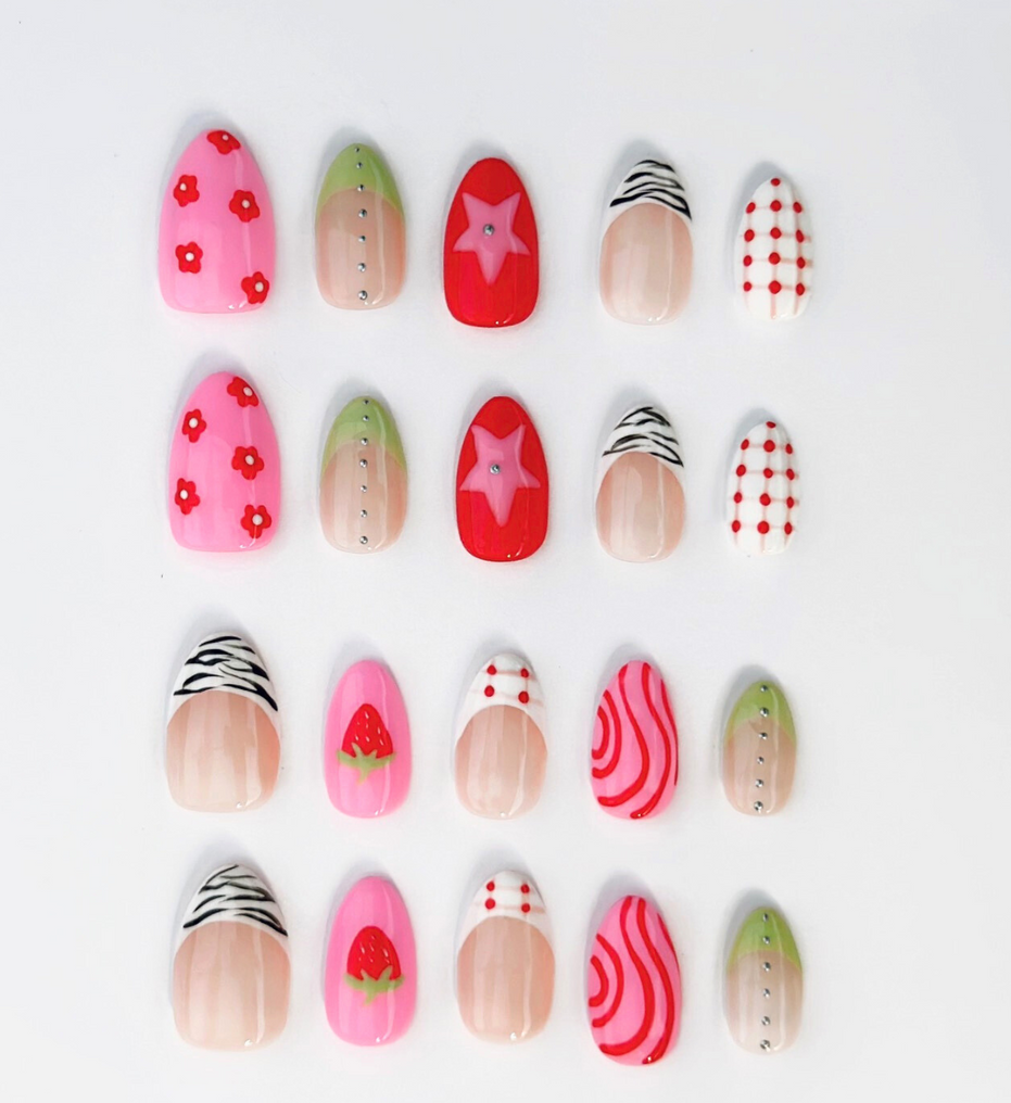 20 Piece Hand-Painted acrylic press-on nails with vibrant colors and designs including strawberries, stars, gingham, zebra print, and french tips. The nail colors are red, light green, light pink, zebra print, and silver details. The vibrant press ons are displayed on a white background